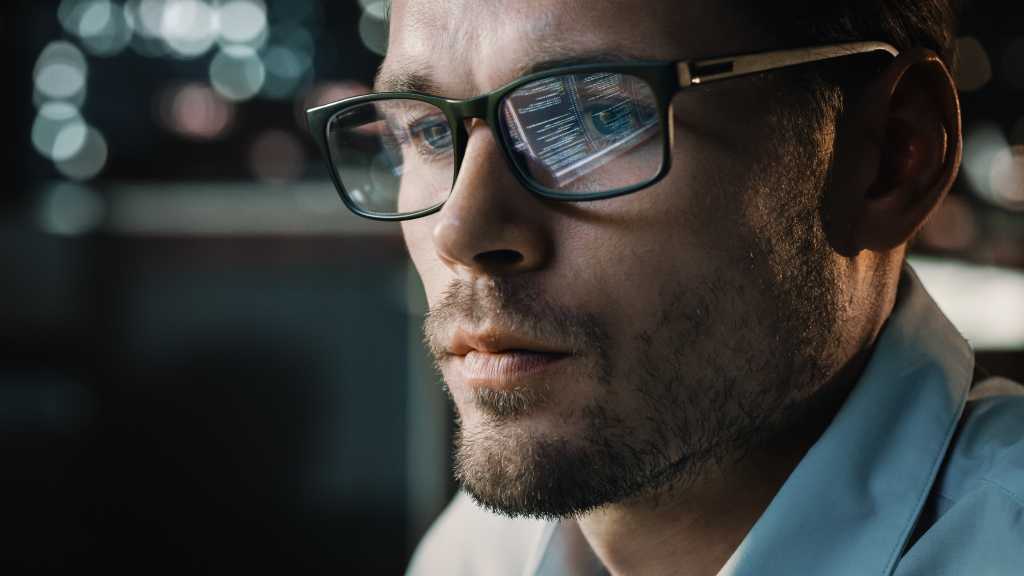 Portrait of Handsome Startup Digital Entrepreneur Working on Computer, Line of Code Reflecting in Glasses. Developer Working on Innovative e-Commerce Application using AI Algorithm to use Big Data