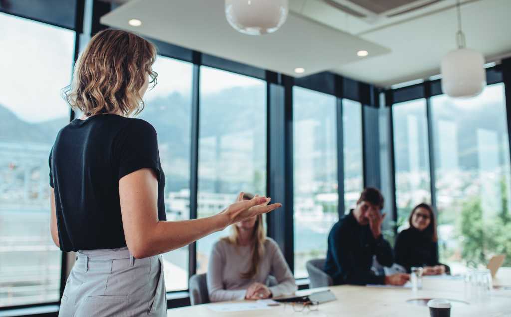 Businesswoman making a presentation to her colleagues in office. Female entrepreneur making a presentation at work.